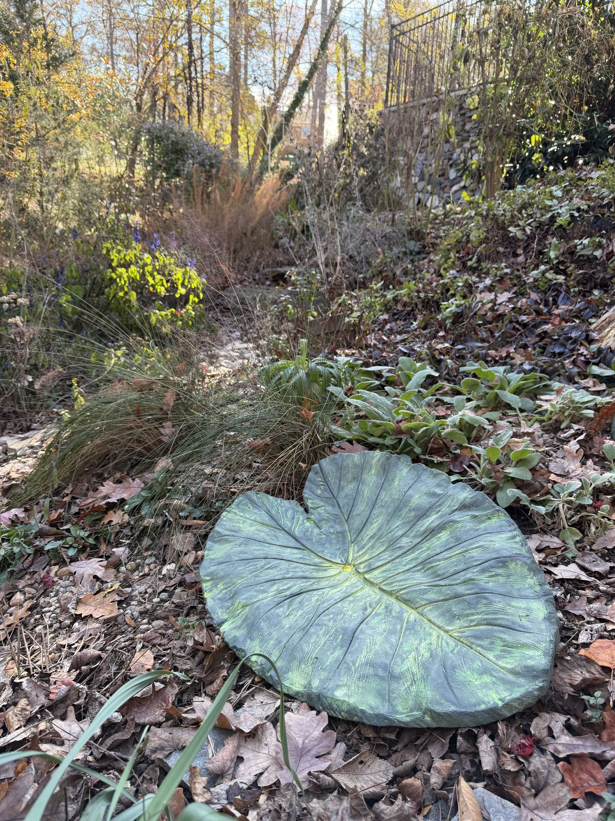 The finished leaf cast placed among grasses and ferns in the garden
